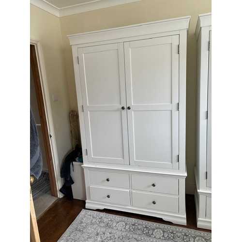 36 - A white two door wardrobe with four drawers below and hanging space above (H200cm W114cm D55cm)