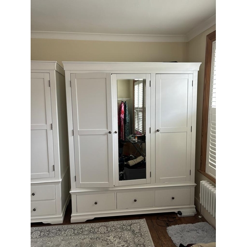 37 - A white three door wardrobe with three drawers below and hanging space above (H200cm W165cm D55cm)