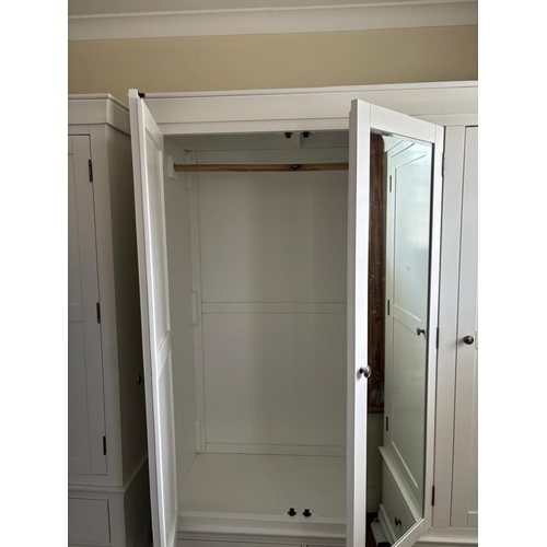 37 - A white three door wardrobe with three drawers below and hanging space above (H200cm W165cm D55cm)