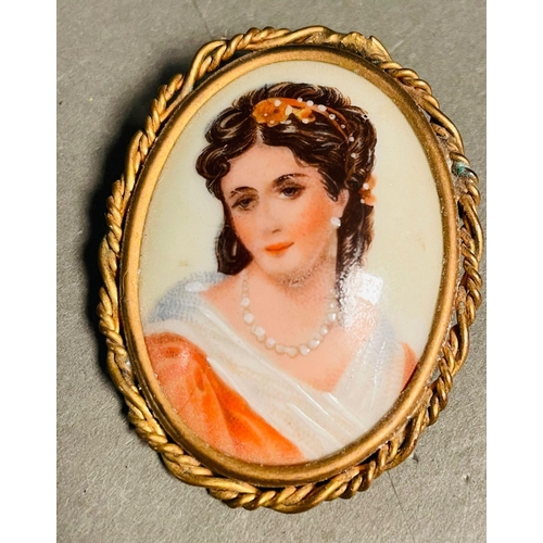 374 - Limoges France porcelain portrait brooch pair from the mid 20th century