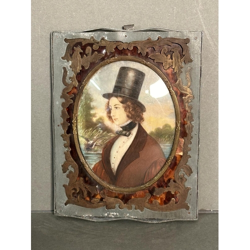 375 - A miniature portrait of a young man in a lead frame with brass and tortoiseshell inlay