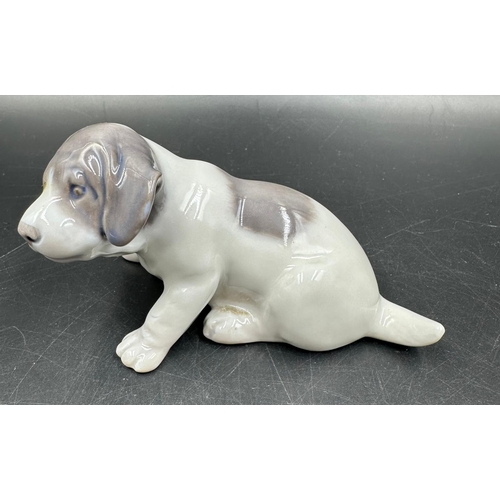 385 - A Beswick figure of a Dalmation dog (8.5cm High) along with a Royal Copenhagen porcelain puppy.