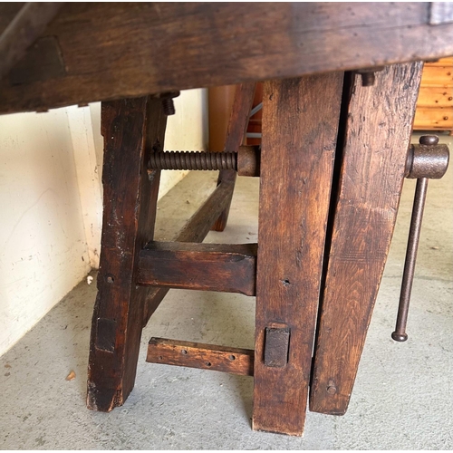 39 - A vintage oak work bench with cast iron vice handles and an A frame base with cross stretcher (H79cm... 