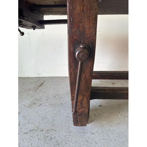 39 - A vintage oak work bench with cast iron vice handles and an A frame base with cross stretcher (H79cm... 