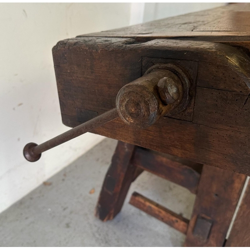 39 - A vintage oak work bench with cast iron vice handles and an A frame base with cross stretcher (H79cm... 