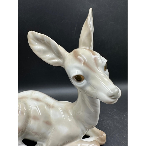 390 - Two Lladro figures Sitting Deer No 1064 and playful cat Number 5091