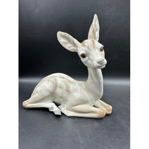 390 - Two Lladro figures Sitting Deer No 1064 and playful cat Number 5091