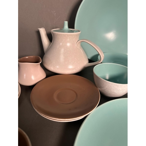 397 - A part pool pottery breakfast set in browns and green and white to include cups, saucers, egg cups a... 