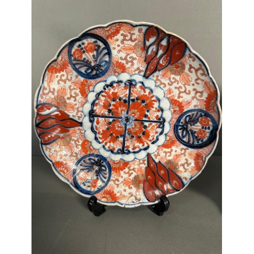 399 - Two Japanese plates in the Imari palette in reds, blues and black