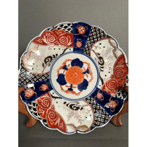 399 - Two Japanese plates in the Imari palette in reds, blues and black