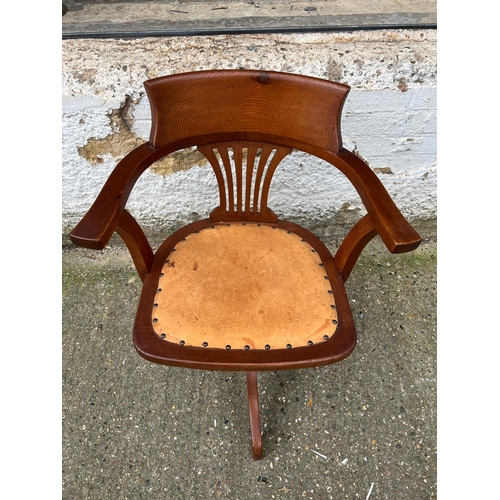 4 - An oak revolving desk chair