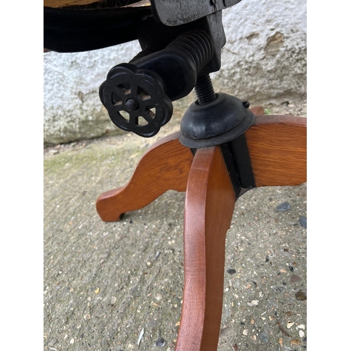 4 - An oak revolving desk chair