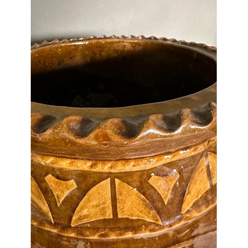 401 - A brown studio pottery planter with crimped rim and floral motif. Height 43