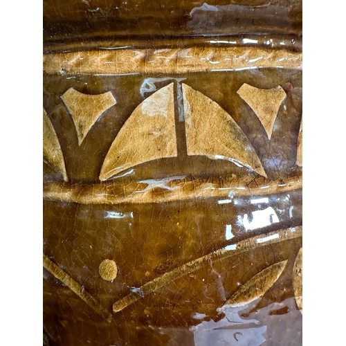 401 - A brown studio pottery planter with crimped rim and floral motif. Height 43