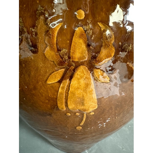 401 - A brown studio pottery planter with crimped rim and floral motif. Height 43