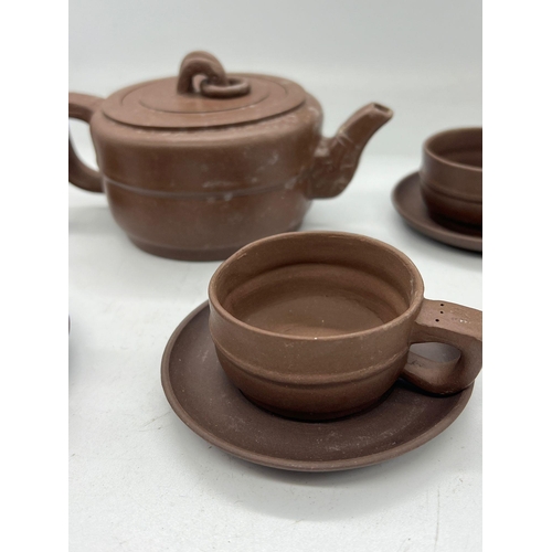 408 - A Chinese clay tea set comprising of four cups and saucers and one teapot