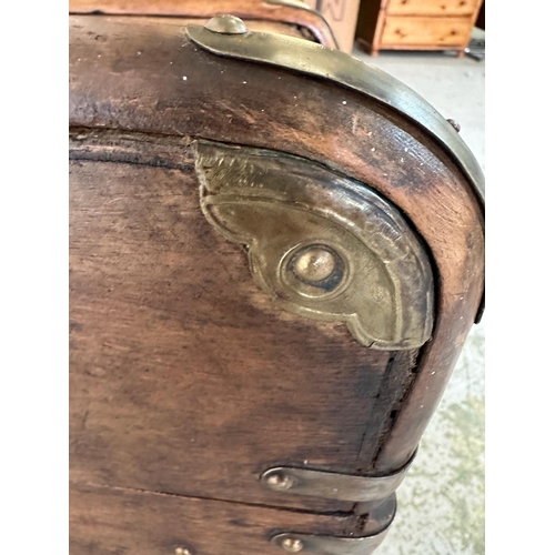 42 - A vintage wooden banded steamer trunk with brass fittings and leather strap handles to ends opening ... 