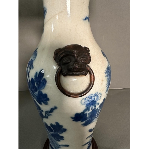 427 - A pair of Chinese blue and white table lamps in a floral bird pattern with foo dogs to side