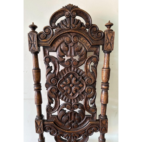 43 - A pair of Victorian style oak hall chairs with carved seats and back, turned supports ending in orna... 