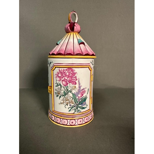 437 - A French lidded mug decorated in pinks and yellows with floral central shield