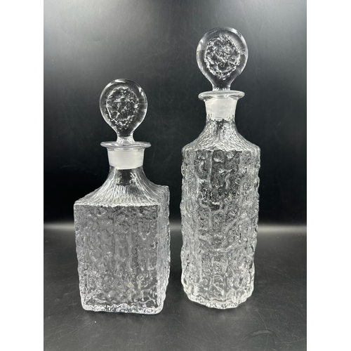 441 - Two Whitefriars clear glass decanters in a moulded bark style form