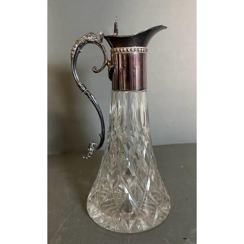 442 - Two cut glass claret jugs with scrolling silver plated handles