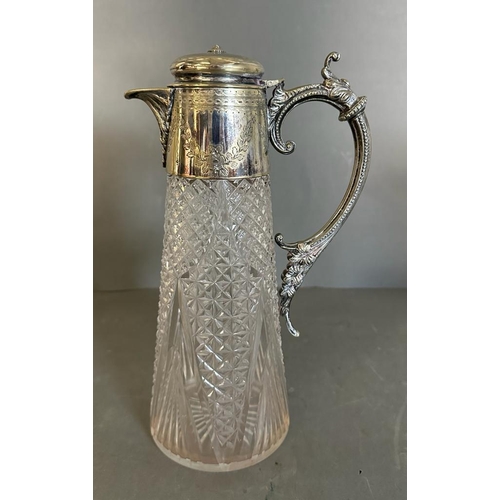 442 - Two cut glass claret jugs with scrolling silver plated handles