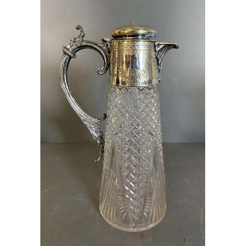 442 - Two cut glass claret jugs with scrolling silver plated handles