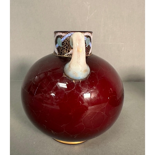 445 - A pair of globular red glass vases with white formed handles and decorative rims in pink, blue and g... 