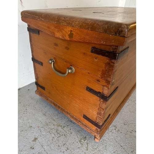 46 - A Middle Eastern style storage trunk with brass handles, metal brackets to corners and diamond inlay... 