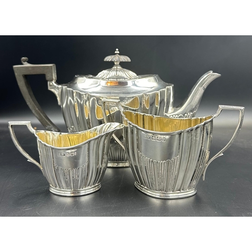 479 - A three piece silver tea service by Lee & Wigfull with a semi fluted design hallmarked for Sheffield... 