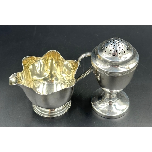 485 - A Mappin & Webb silverplated milk jug and an unmarked pepper pot.