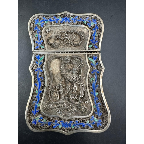 501 - A 19th Century Chinese silver wirework card holder with serpentine edge and floral border