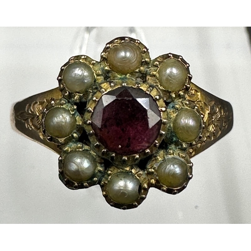 511 - A 9ct gold daisy style ring with central ruby and seed pearls, approximate size Q and weight 2.2g