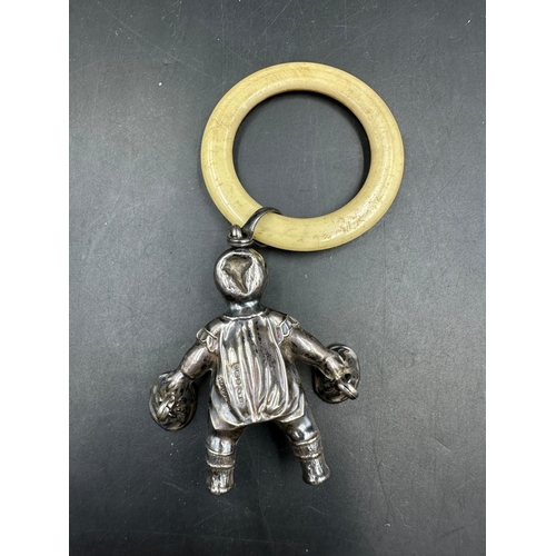 512 - An antique silver babies rattle by Crisford & Norris Ltd, hallmarked for Birmingham 1931