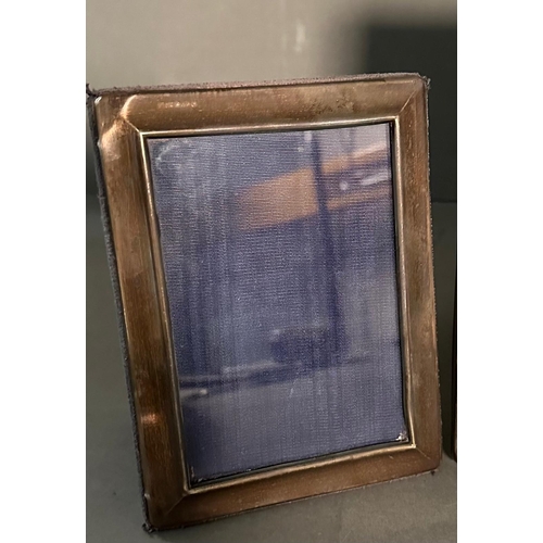 528 - Three silver photograph frames marked 925 (Largest 17cm x 22cm)