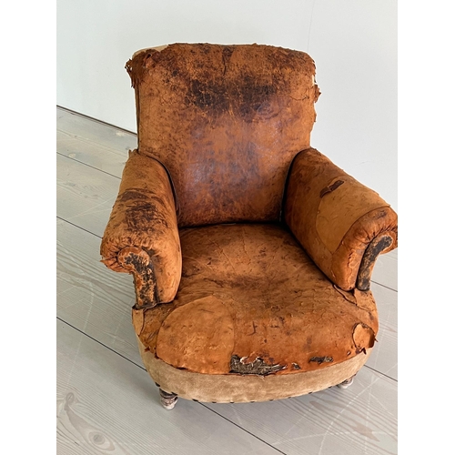 53 - An antique leather club chair in a distresses manner (H84cm W87cm D79cm SH32cm