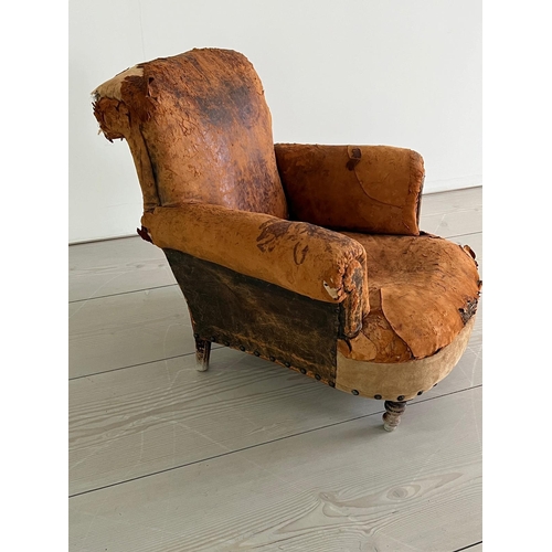 53 - An antique leather club chair in a distresses manner (H84cm W87cm D79cm SH32cm