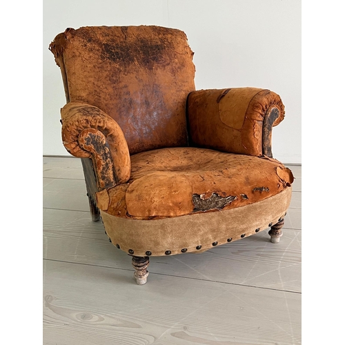 53 - An antique leather club chair in a distresses manner (H84cm W87cm D79cm SH32cm