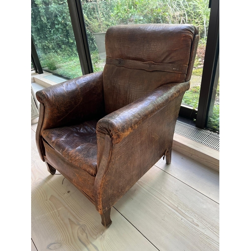 54 - An antique leather club chair in distressed manner with scrolling arms (H95cm W71cm D31cm SH43cm)Cro... 