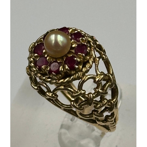 548 - An Arabian gold cocktail ring with ruby and central pearl, approximate total weight 6.7g. Size N