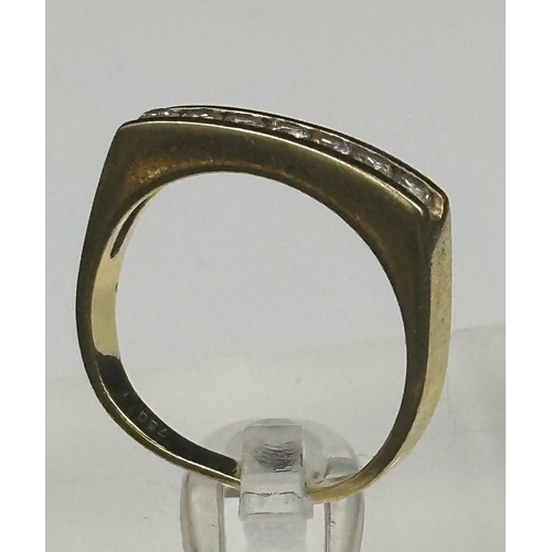 551 - An 18ct gold ring with seven small diamonds and an approximate weight of 4.3g. Size N