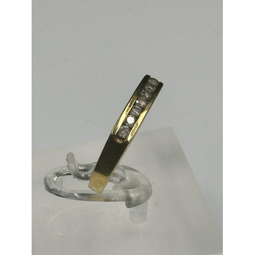 551 - An 18ct gold ring with seven small diamonds and an approximate weight of 4.3g. Size N