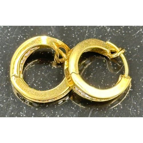 590 - A Gold diamond hoop earrings mounted in 18ct gold. Signed T&Co. Total diamond weight approximately 0... 