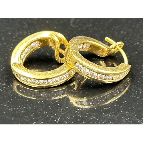 590 - A Gold diamond hoop earrings mounted in 18ct gold. Signed T&Co. Total diamond weight approximately 0... 