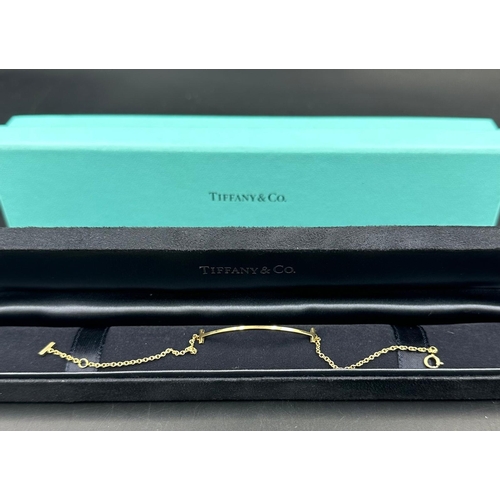 592 - A Tiffany & Co Tiffany T Smile bracelet in 18ct yellow gold in original box.