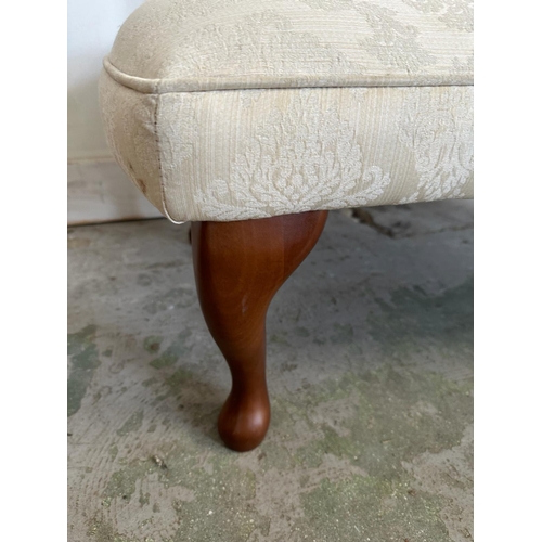 6 - A small button back chaise lounge, upholstered in a cream floral pattern