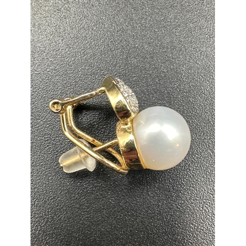 603 - A pair of 14ct gold pearl and diamond earrings