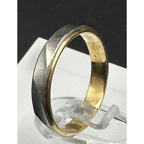 609 - An 18ct yellow gold and platinum wedding band style ring approximate weight 2.7g and size K.