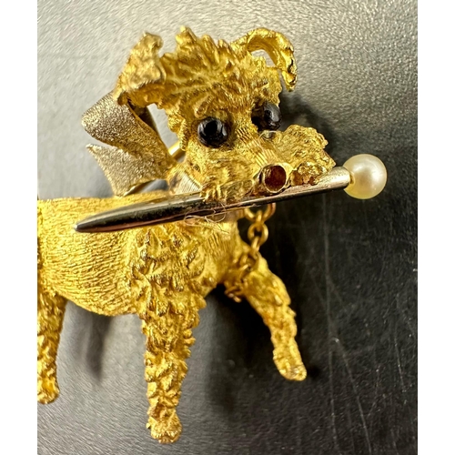 617 - An 18ct gold brooch of a small terrier with pearl capped stick in its mouth (Total weight 5.8g)